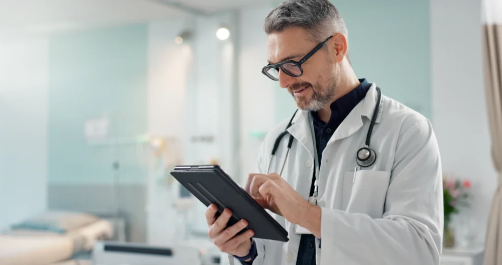 Healthcare senior man doctor with tablet